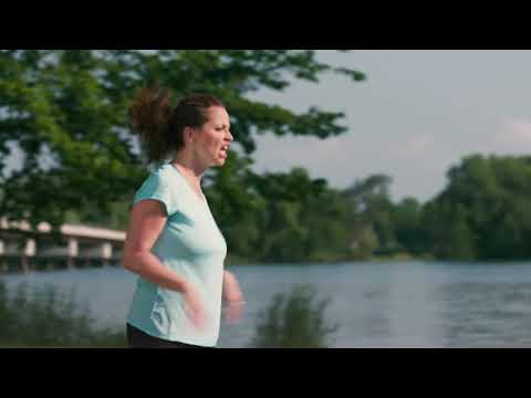 Toro Recycler Personal Pace SmartStow 22in Mower video still showing a person beside a lake with trees behind